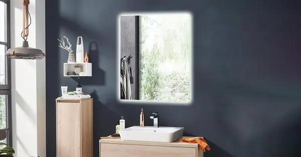 Backlit rectangular mirror above a wooden vanity unit